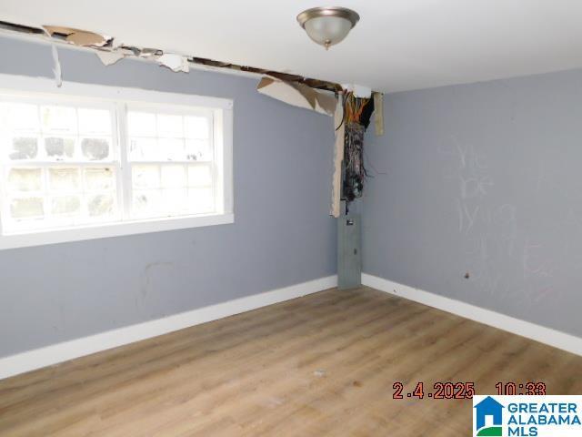 unfurnished room with hardwood / wood-style floors