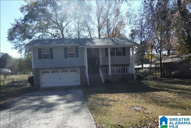 split foyer home with a garage and covered porch