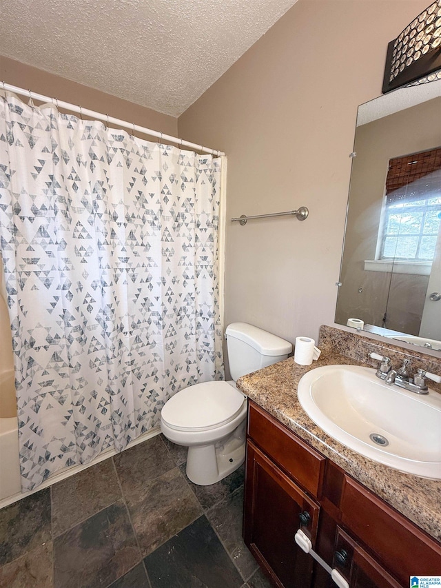 bathroom featuring vanity, toilet, and a textured ceiling