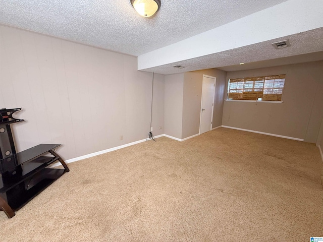 basement featuring a textured ceiling and carpet