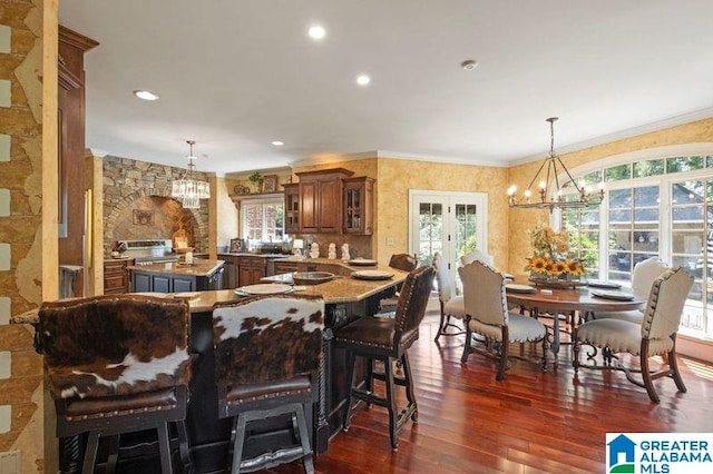 dining area featuring plenty of natural light, dark hardwood / wood-style floors, and a chandelier