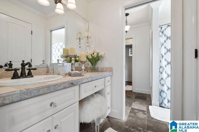 bathroom with crown molding and vanity