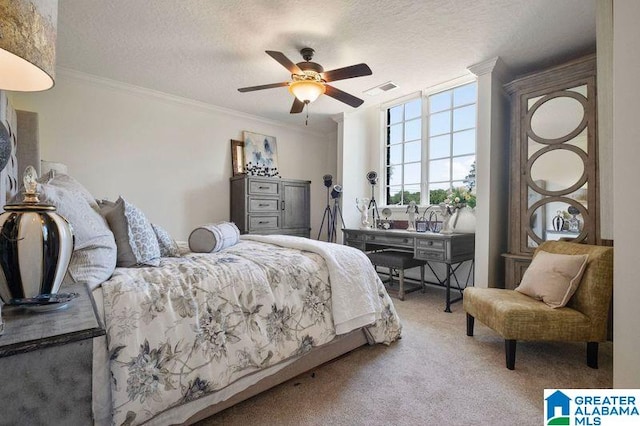 bedroom featuring ceiling fan, ornamental molding, a textured ceiling, and carpet flooring