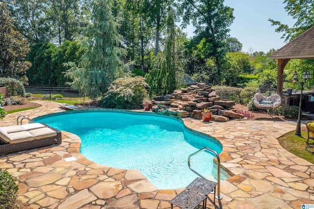 view of swimming pool featuring a diving board and a patio area