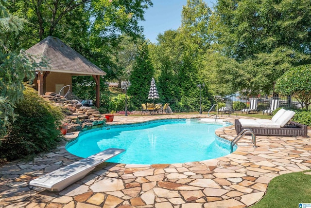 view of pool with a gazebo, a diving board, and a patio area