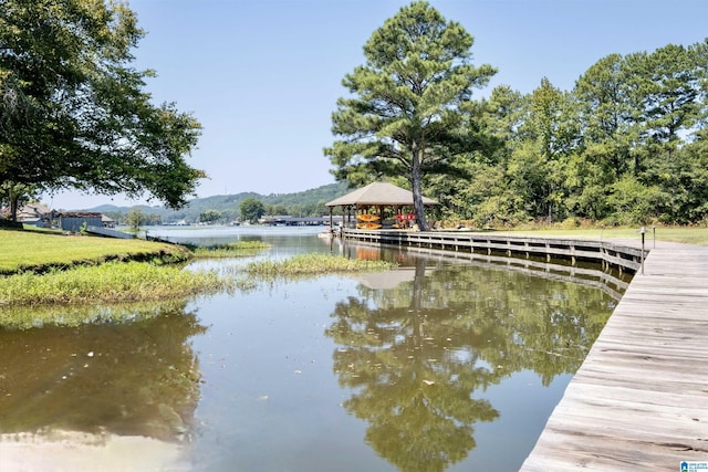 view of dock featuring a water view and a gazebo