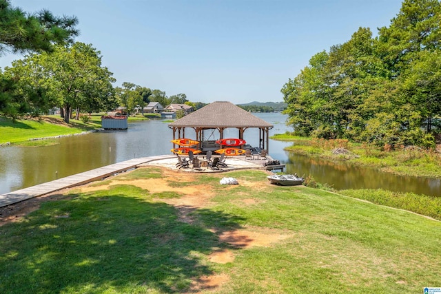 view of dock featuring a gazebo, a water view, and a lawn