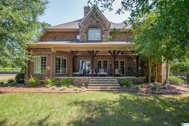 view of front of house with a front yard and french doors