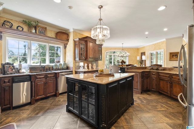 kitchen featuring dark brown cabinets, a center island, and appliances with stainless steel finishes