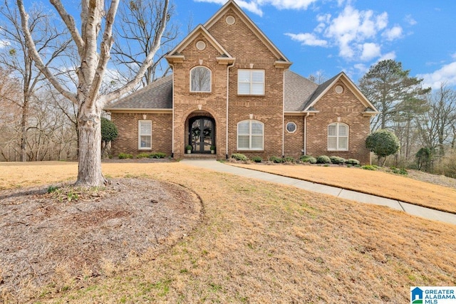 view of front property featuring a front lawn and french doors