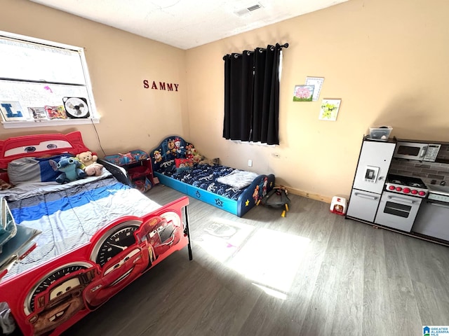 bedroom with hardwood / wood-style flooring