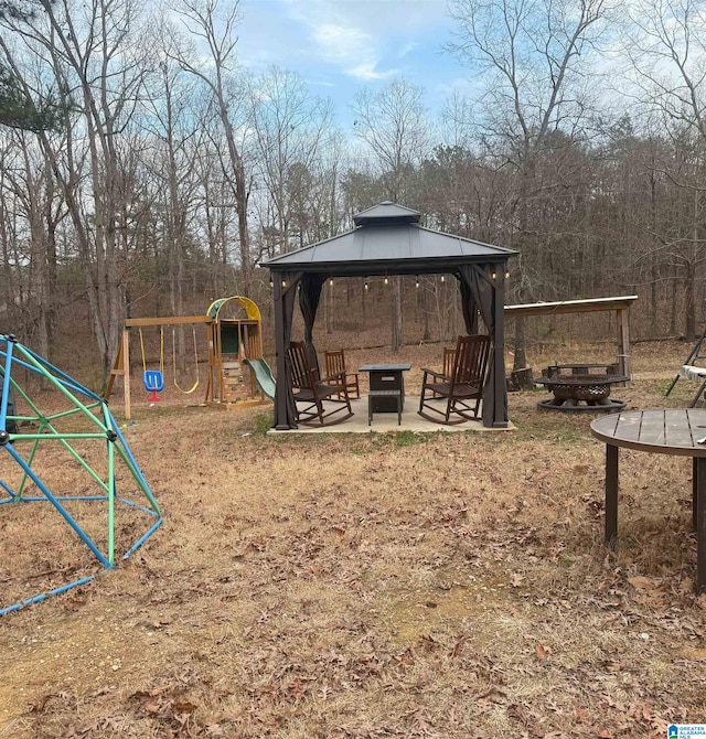 view of playground featuring a gazebo and a fire pit