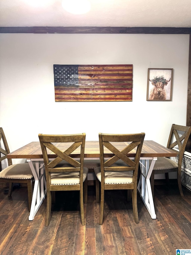 dining area featuring breakfast area, crown molding, and dark hardwood / wood-style flooring