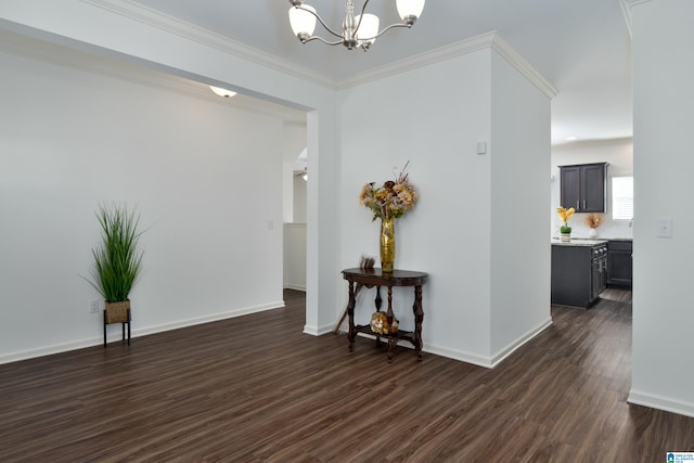 corridor featuring ornamental molding, dark hardwood / wood-style floors, and a notable chandelier