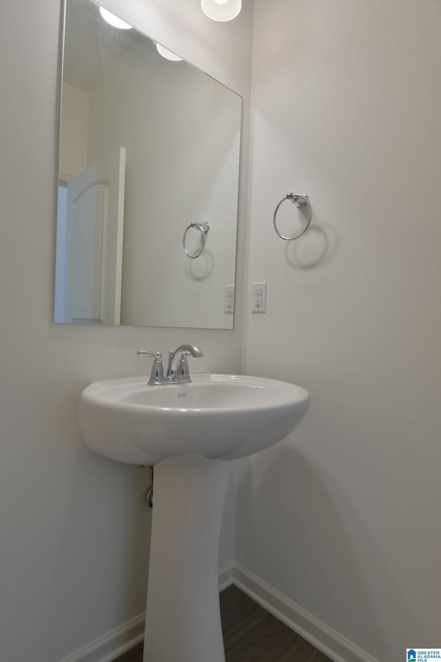 bathroom with hardwood / wood-style flooring and sink