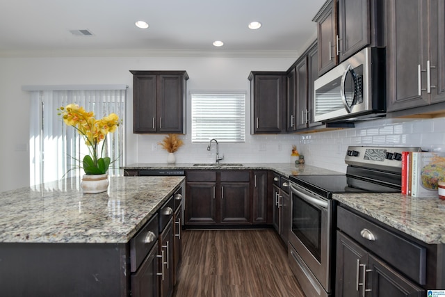 kitchen featuring sink, stainless steel appliances, tasteful backsplash, ornamental molding, and dark hardwood / wood-style flooring