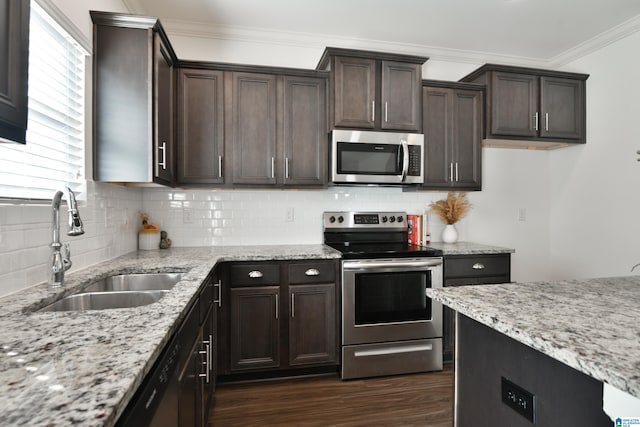 kitchen with appliances with stainless steel finishes, dark hardwood / wood-style floors, sink, and dark brown cabinets