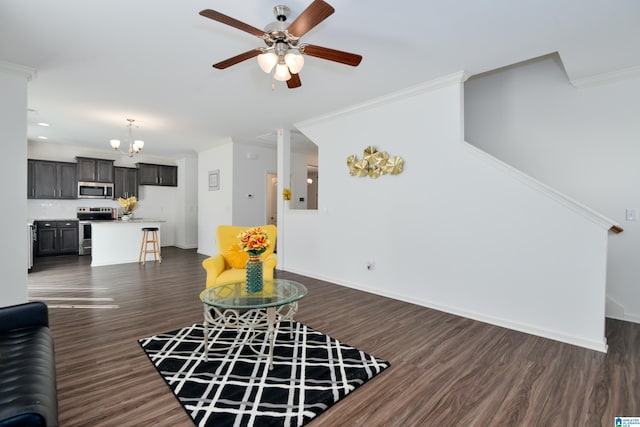 living room with dark wood-type flooring, ornamental molding, and ceiling fan