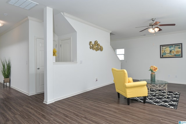 living area with crown molding, ceiling fan, and dark wood-type flooring