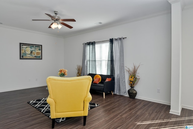 living area featuring dark hardwood / wood-style flooring, crown molding, and ceiling fan