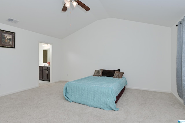 bedroom featuring lofted ceiling, light carpet, ceiling fan, and ensuite bath