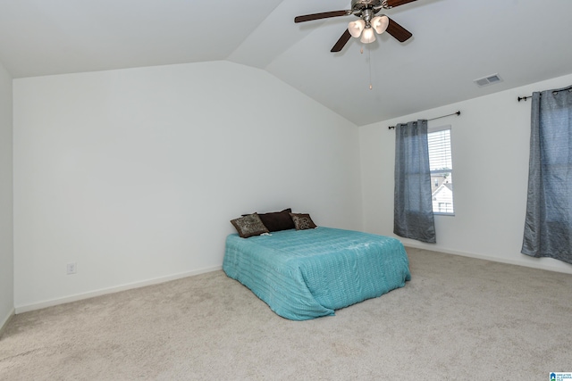 bedroom with vaulted ceiling, light colored carpet, and ceiling fan