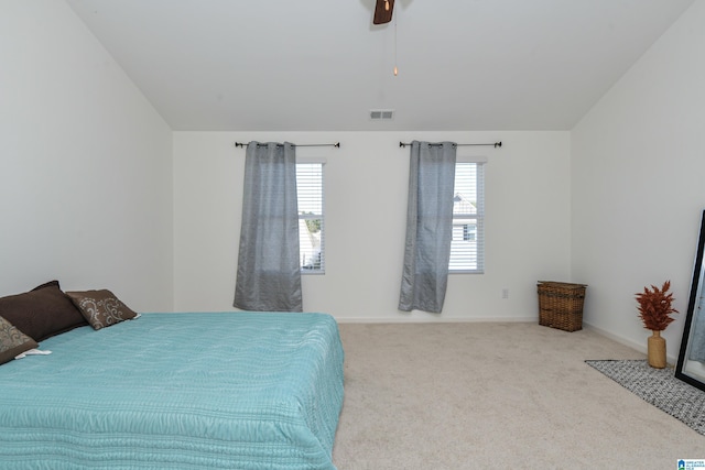 carpeted bedroom with ceiling fan and lofted ceiling