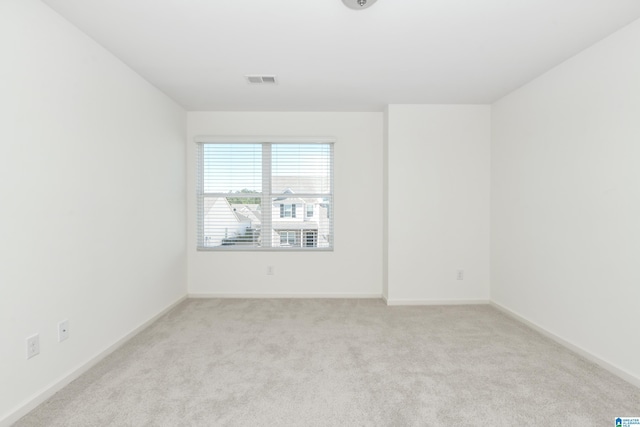 spare room with light colored carpet