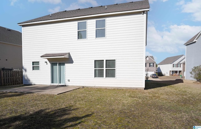 back of property featuring a patio and a yard