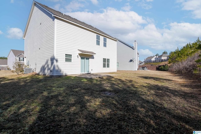 rear view of house featuring a yard, a patio area, and central air condition unit