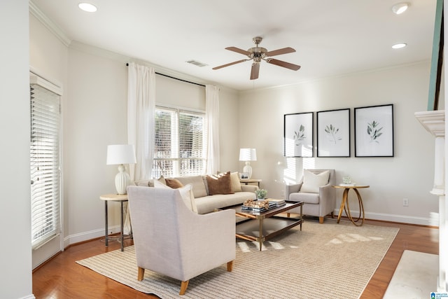 living room featuring crown molding, hardwood / wood-style flooring, and ceiling fan