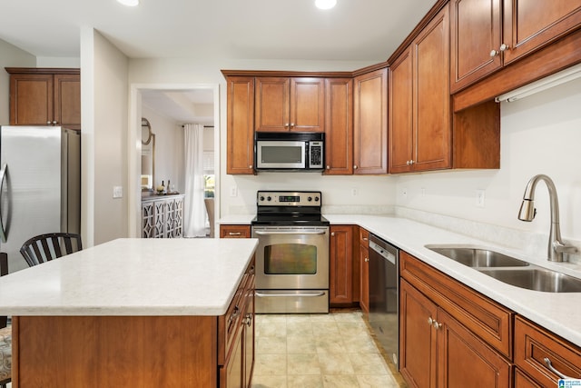 kitchen featuring light tile patterned flooring, sink, a kitchen bar, a center island, and stainless steel appliances