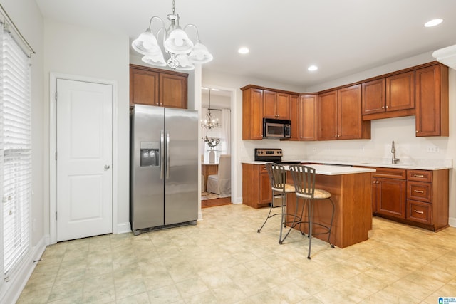 kitchen with hanging light fixtures, stainless steel appliances, a center island, and a chandelier