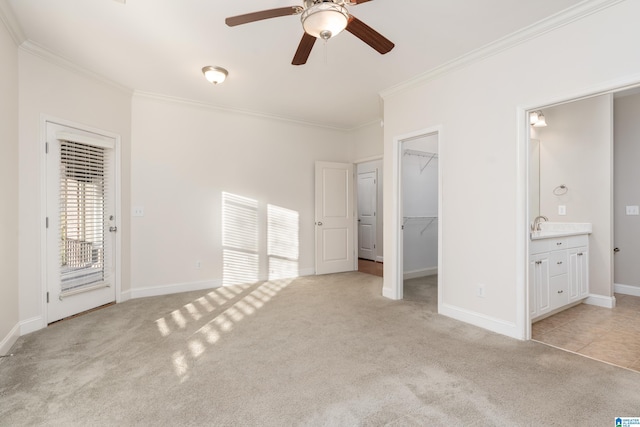 unfurnished bedroom with crown molding, light carpet, and access to outside