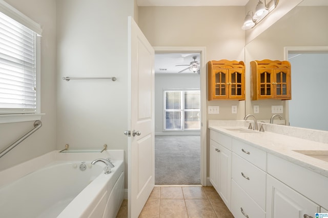 bathroom with ceiling fan, vanity, a bath, and tile patterned flooring