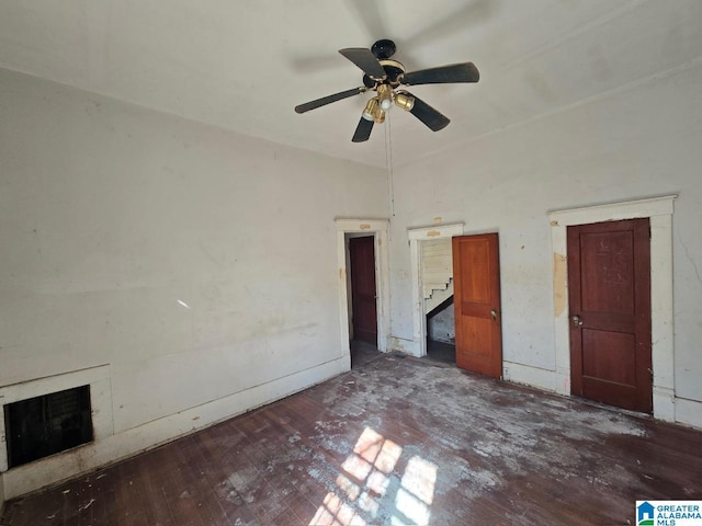 unfurnished bedroom with ceiling fan and dark hardwood / wood-style flooring