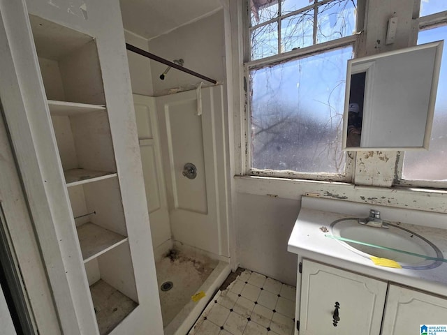 bathroom with vanity and a shower