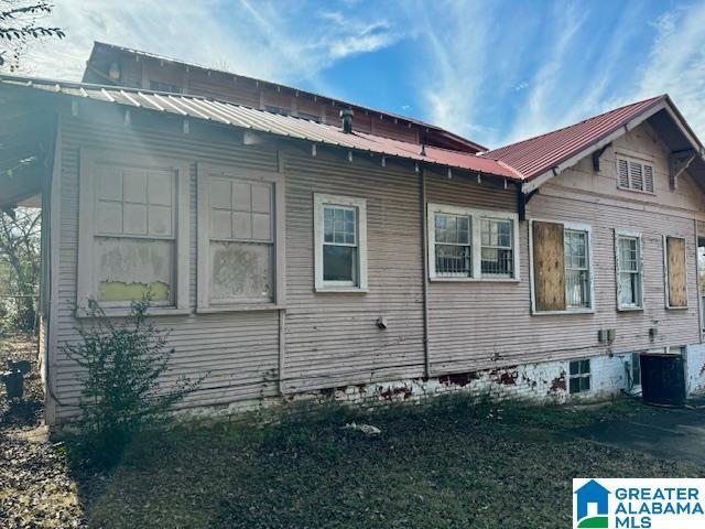 view of side of property with central AC