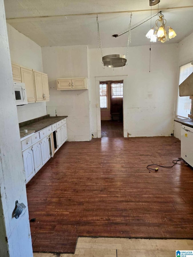 kitchen featuring dark hardwood / wood-style floors, decorative light fixtures, and a notable chandelier