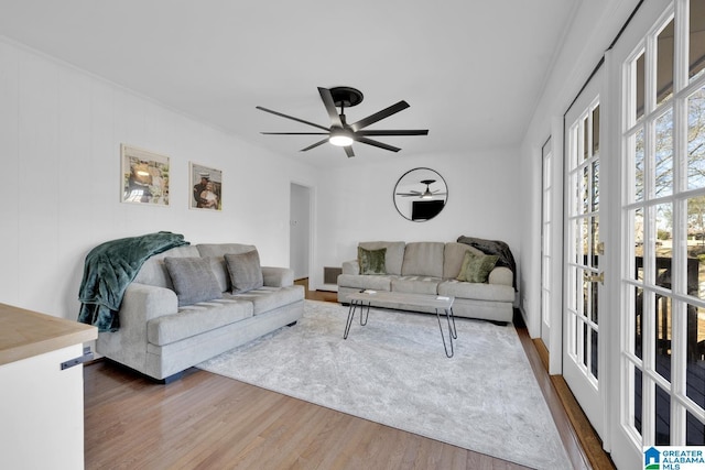 living room featuring ceiling fan and dark hardwood / wood-style flooring