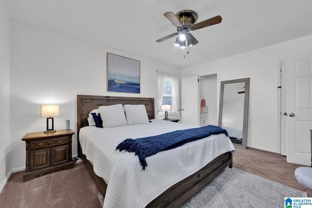 carpeted bedroom featuring ensuite bathroom and ceiling fan