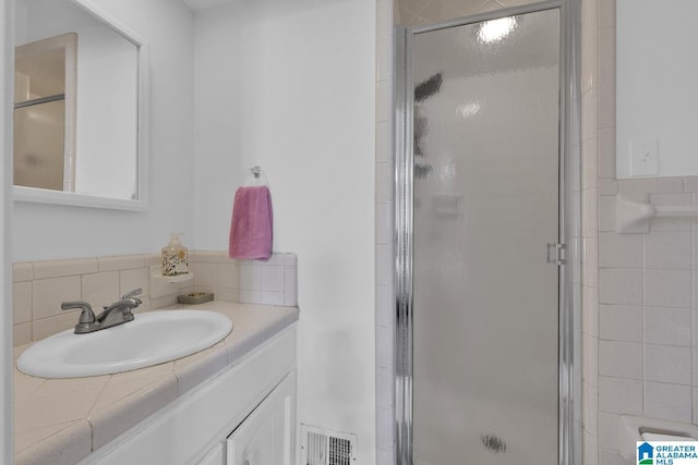 bathroom with vanity and walk in shower