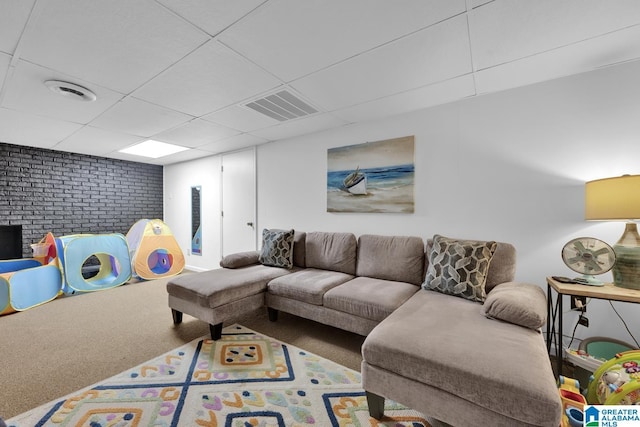 carpeted living room with a paneled ceiling