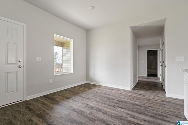 spare room with dark hardwood / wood-style floors