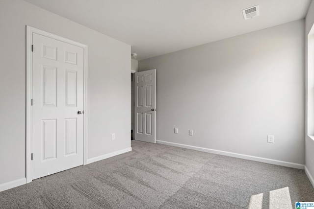 unfurnished bedroom with light colored carpet