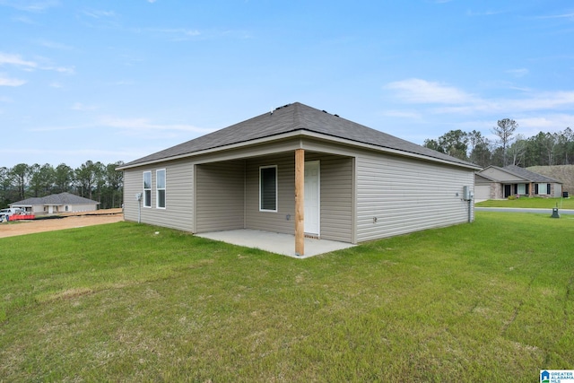 back of property featuring a patio and a lawn