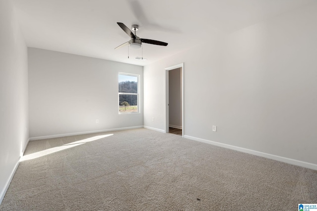 carpeted spare room featuring ceiling fan