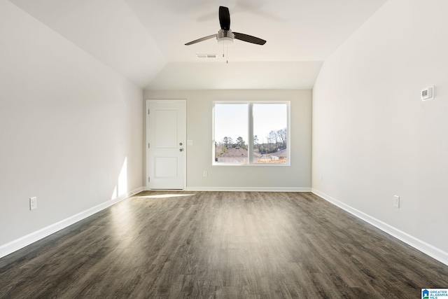 spare room with ceiling fan, lofted ceiling, and dark hardwood / wood-style flooring