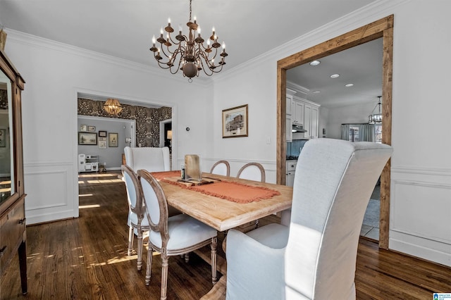 dining area featuring a notable chandelier, crown molding, and dark hardwood / wood-style floors