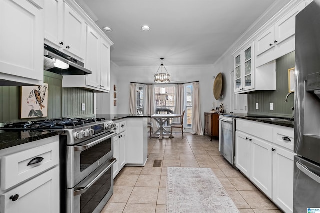 kitchen featuring appliances with stainless steel finishes, pendant lighting, light tile patterned floors, and white cabinets